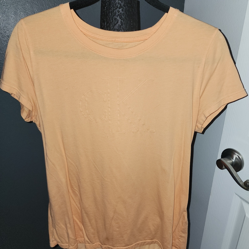 Calvin Klein Light Orange Tee with Embossed Logo.. Never Worn.